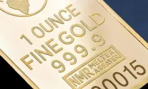 Sztabka złota z napisem "1 OUNCE FINE GOLD 999.9" i numerem seryjnym.